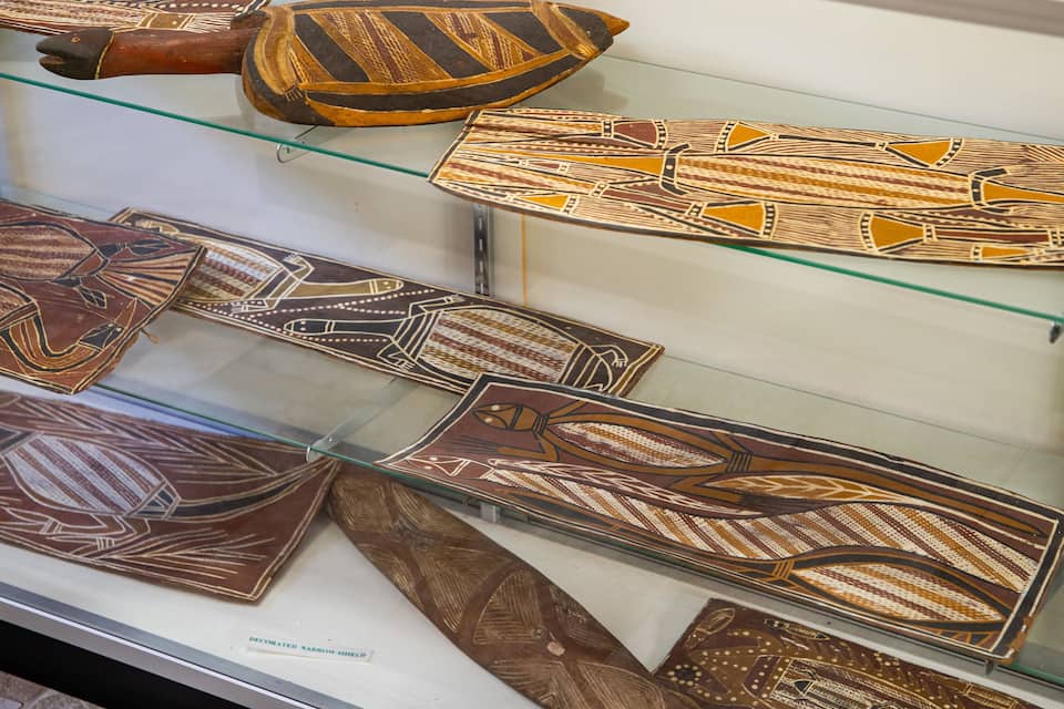 A display of decorated narrow shields.