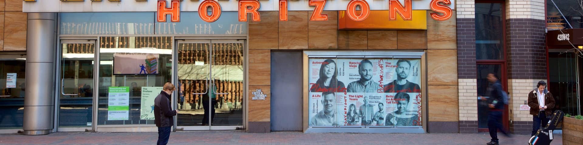 Hell\'s Kitchen featuring signage as well as an individual male