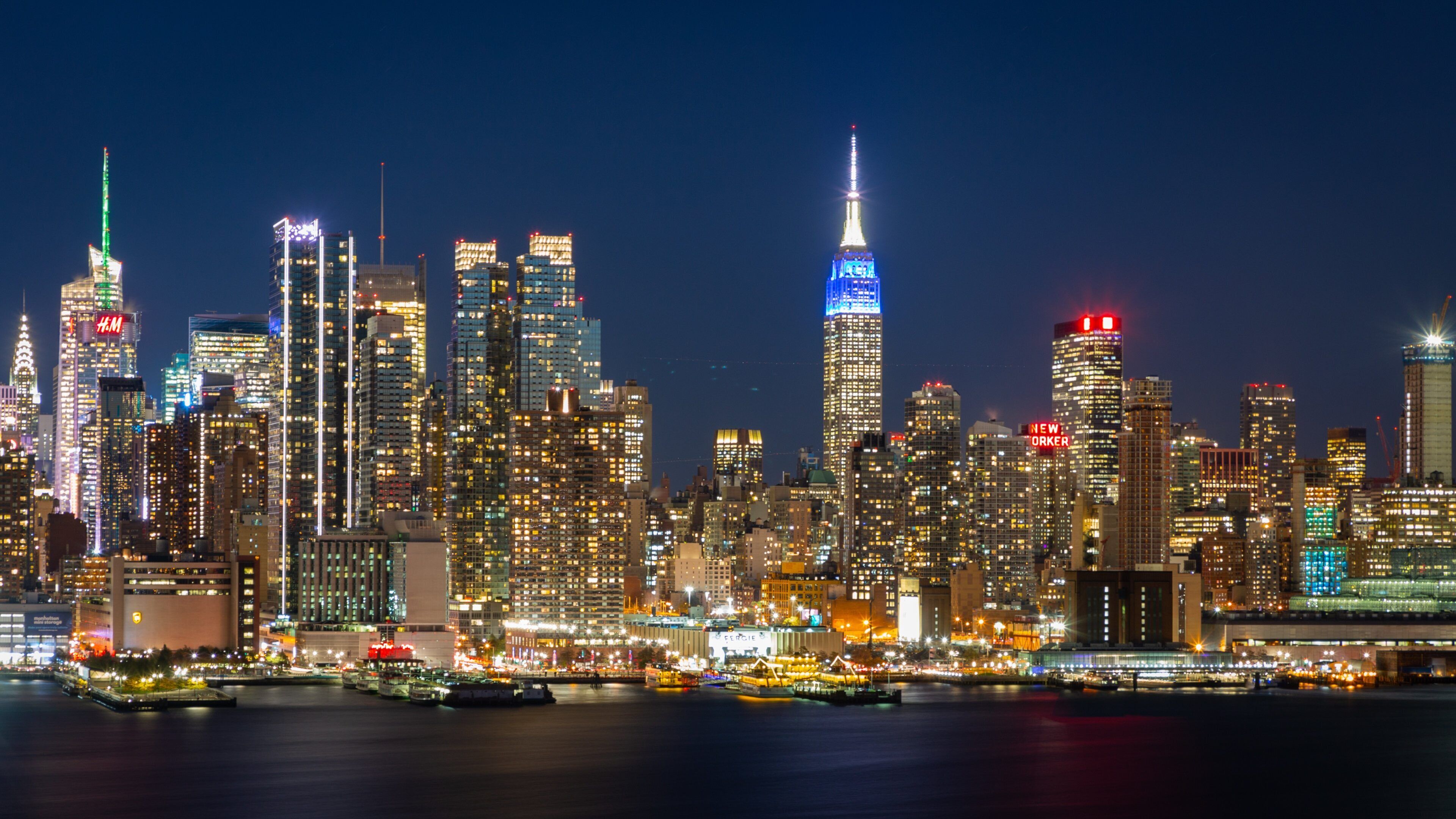 Midtown showing a bay or harbor, night scenes and a city