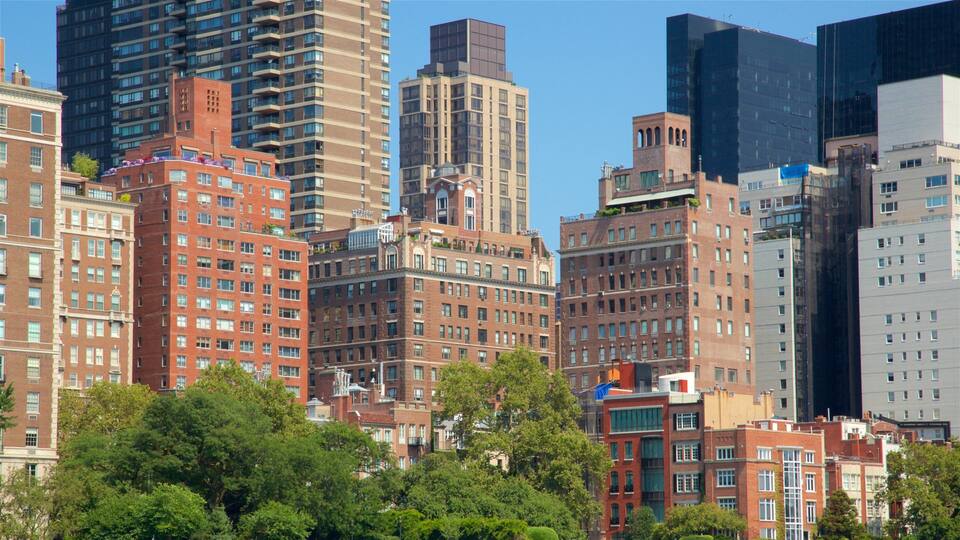 A cityscape with a mix of modern and historic buildings, including a prominent red brick building and a tall skyscraper.