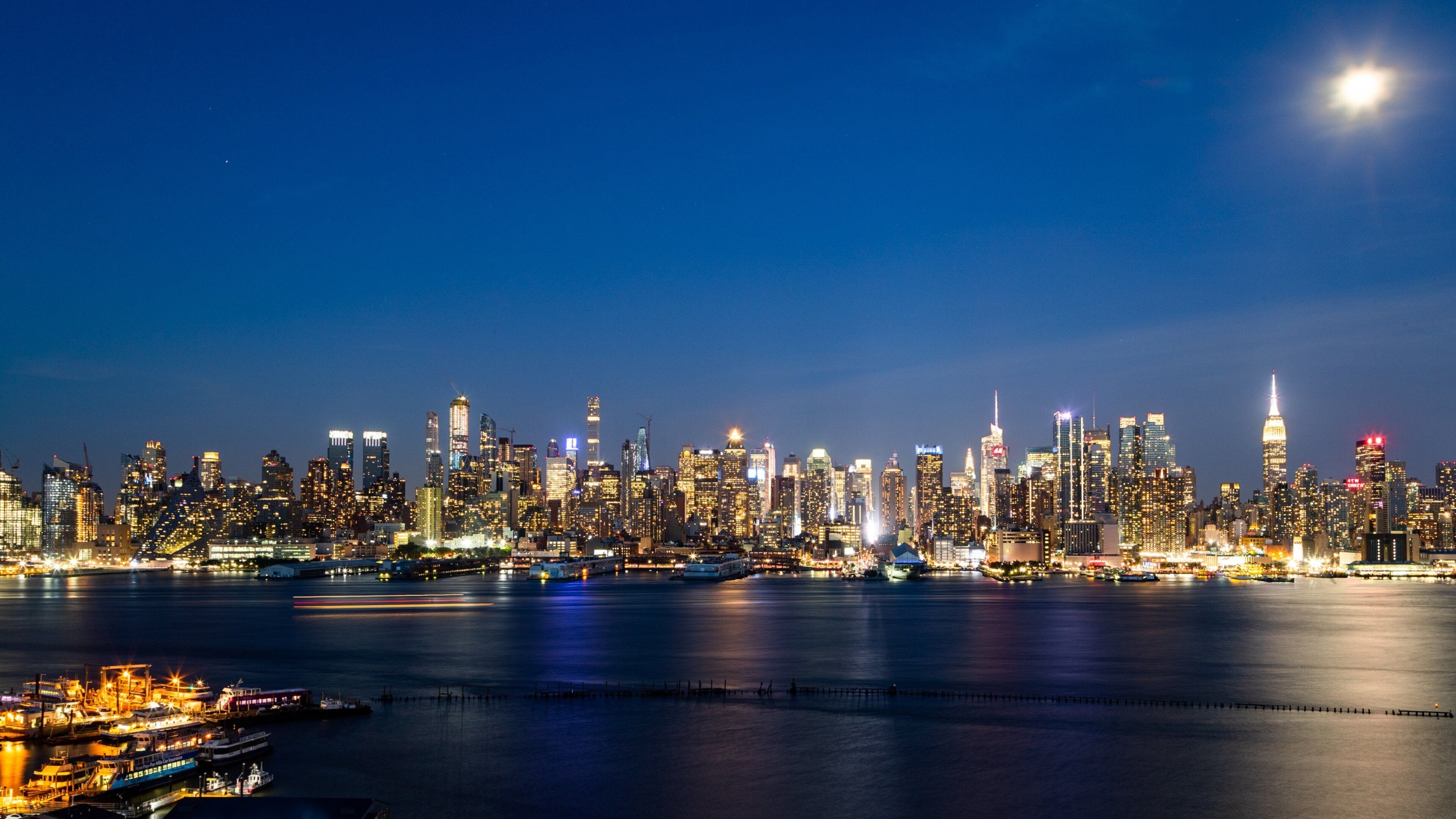 Midtown showing a bay or harbor, a city and night scenes