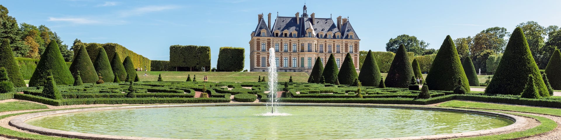 Panoramic view of Parc and chateau de Sceaux with a fountain in foreground - Hauts-de-Seine, France.