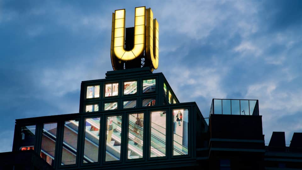 A building with a large illuminated 'U' sign on top and multiple windows.
