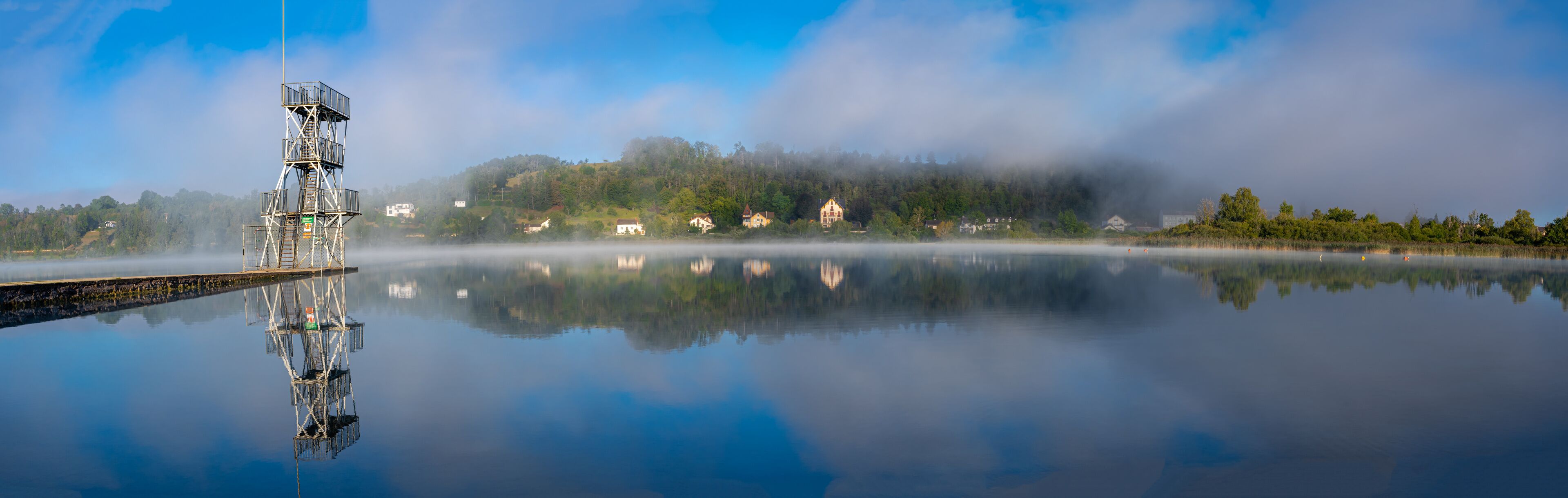 Clairvaux-Les-Lacs, France - 09 02 2020: Fog and reflections on the big lake - La Raillette