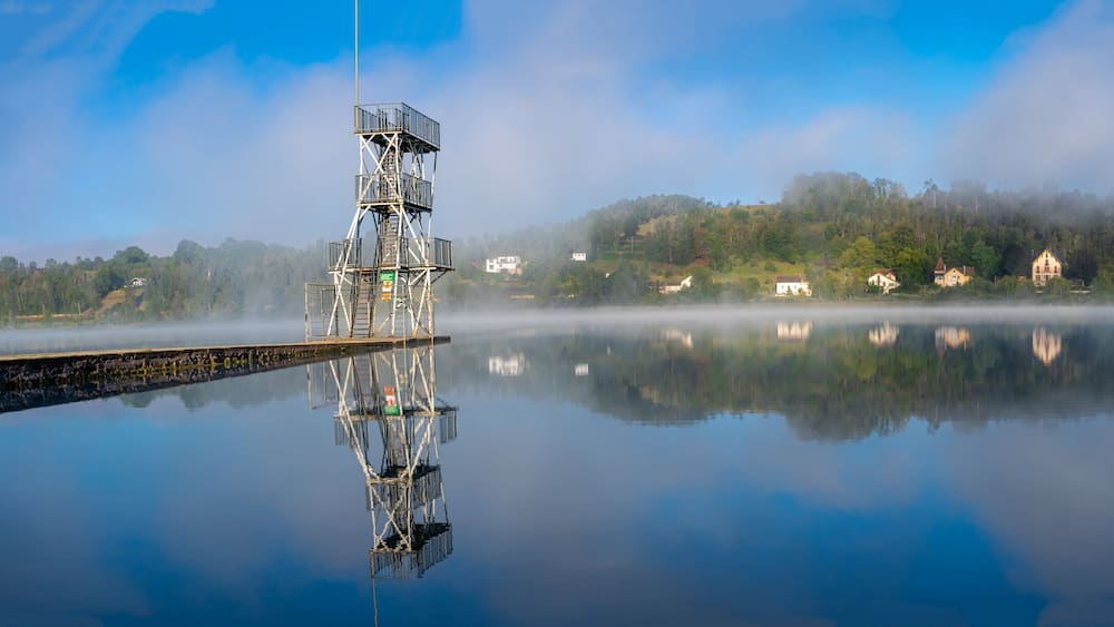 Clairvaux-Les-Lacs, France - 09 02 2020: Fog and reflections on the big lake - La Raillette