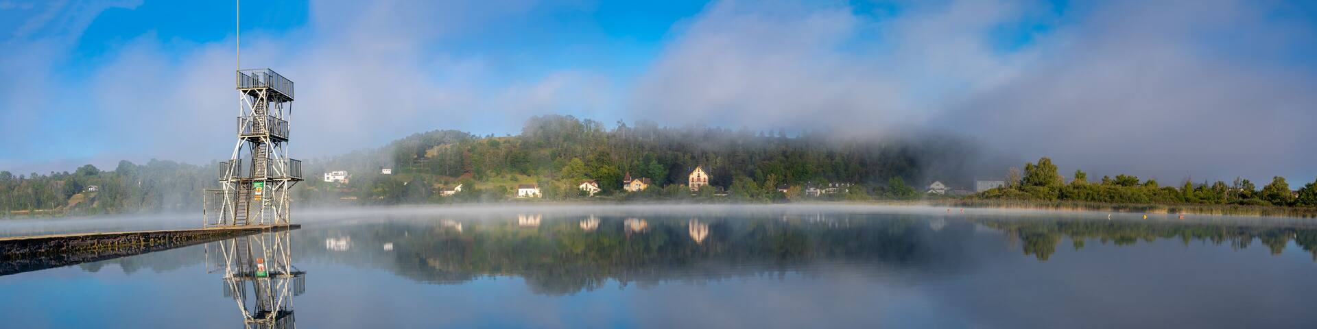 Clairvaux-Les-Lacs, France - 09 02 2020: Fog and reflections on the big lake - La Raillette