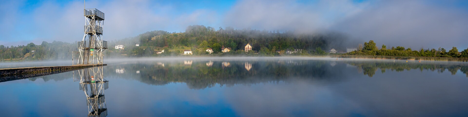 Clairvaux-Les-Lacs, France - 09 02 2020: Fog and reflections on the big lake - La Raillette