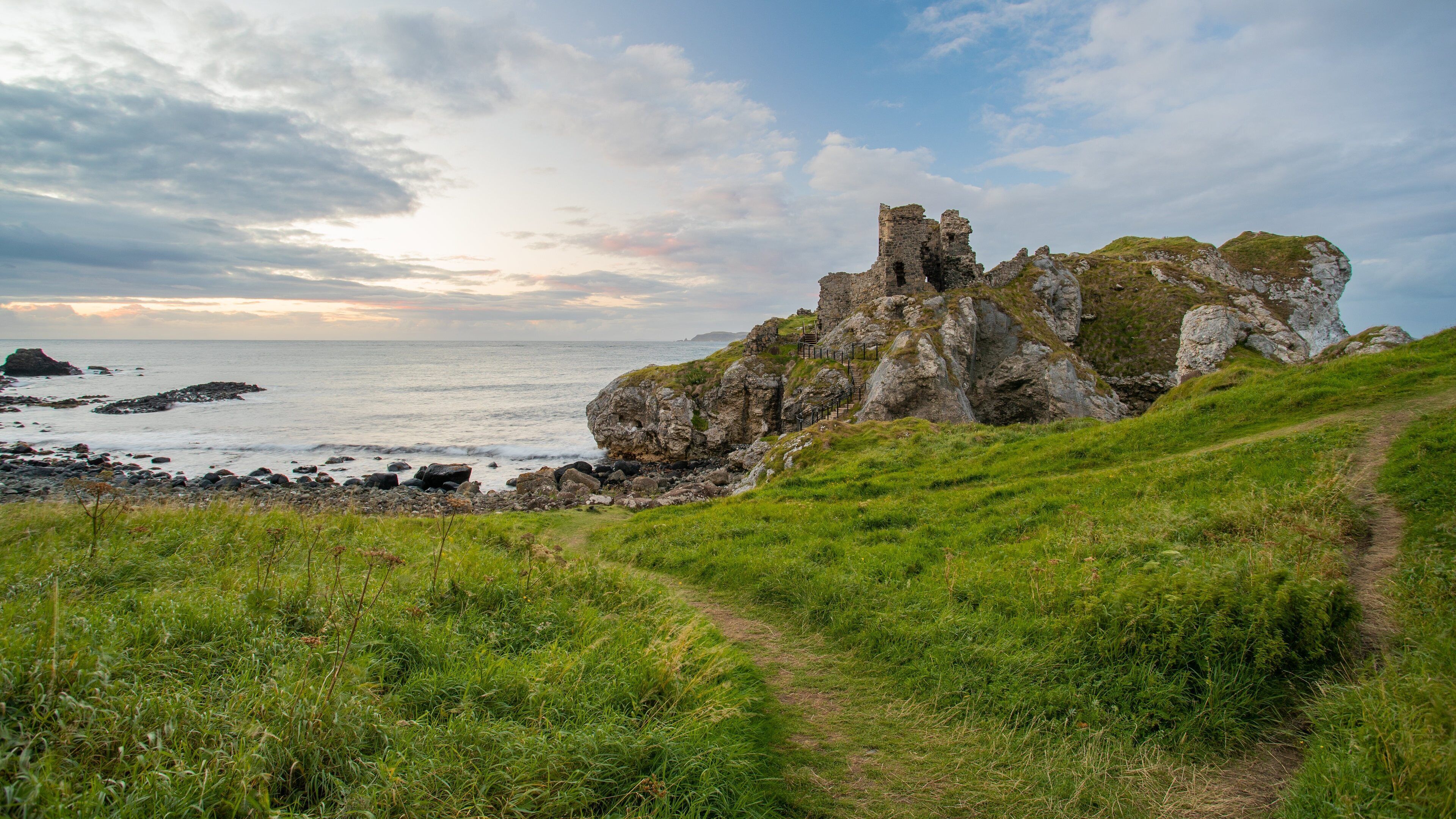 Kinbane Castle showing rocky coastline, a sunset and general coastal views