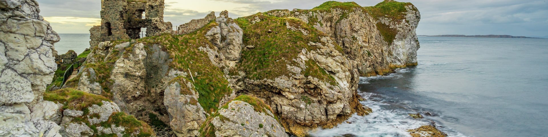 Kinbane Castle which includes general coastal views and rugged coastline