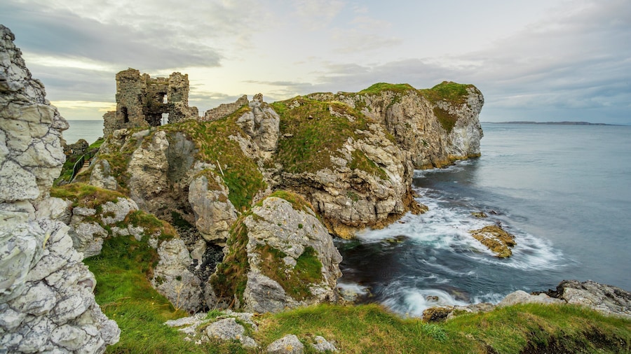 Kinbane Castle which includes general coastal views and rugged coastline