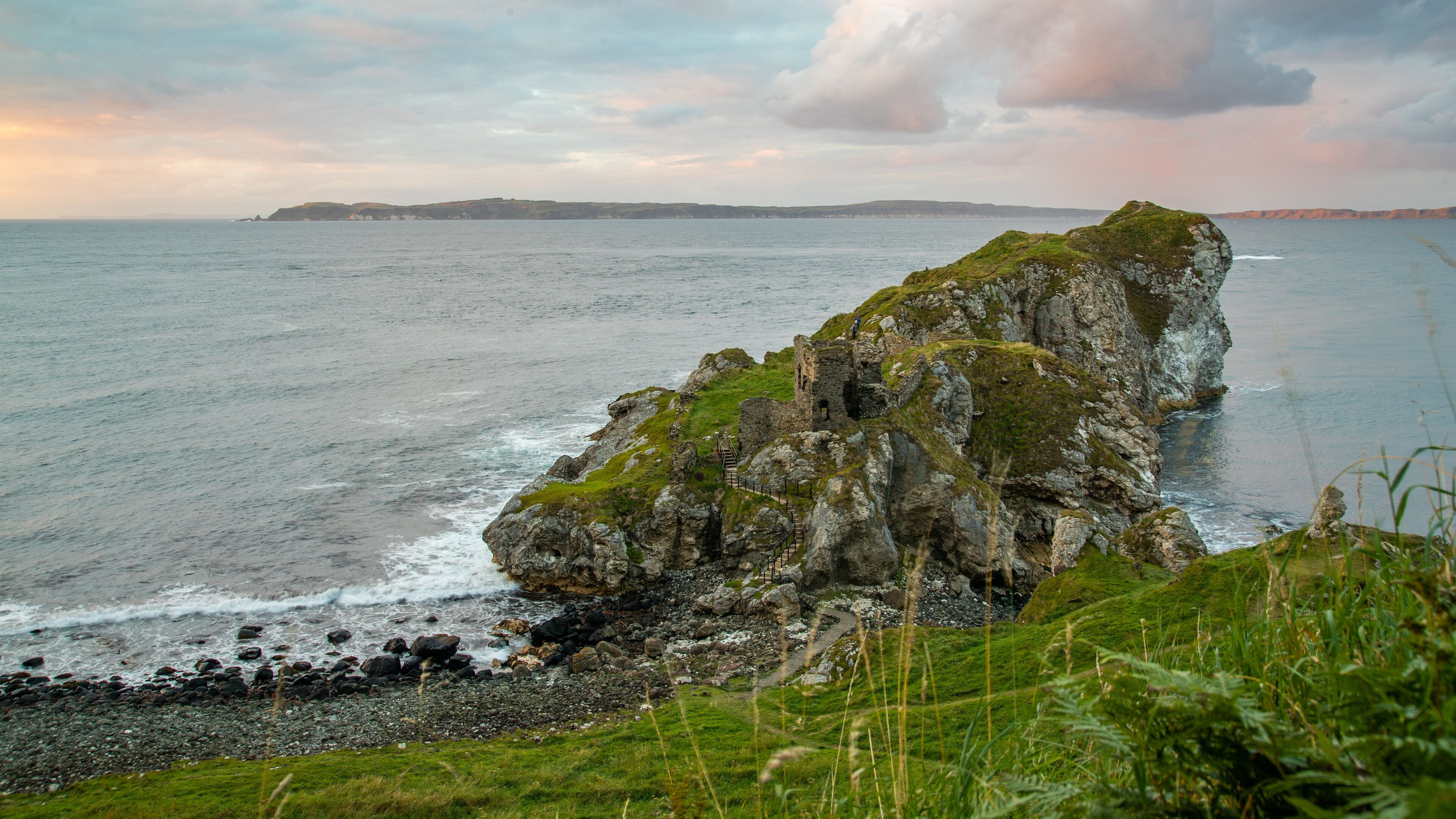 Kinbane Castle featuring rocky coastline, general coastal views and a sunset