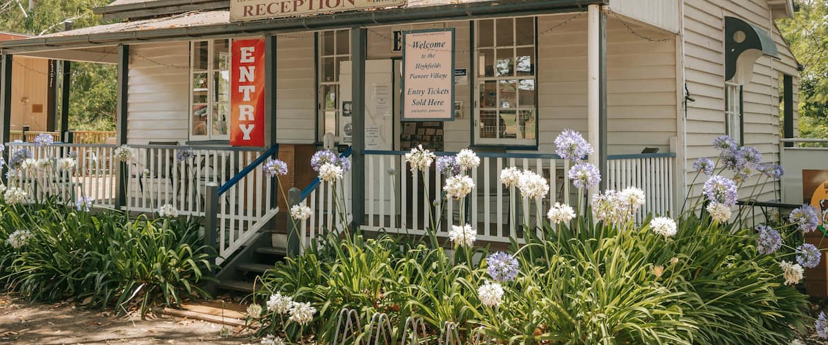 Highfields Pioneer Village which includes signage and flowers