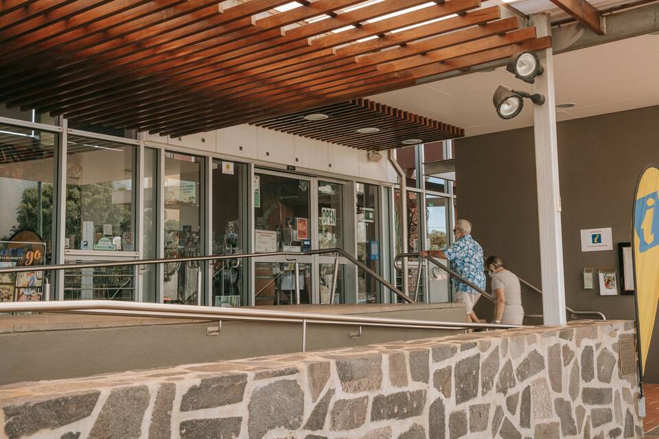 A building with a stone facade, wooden ceiling, and glass windows.