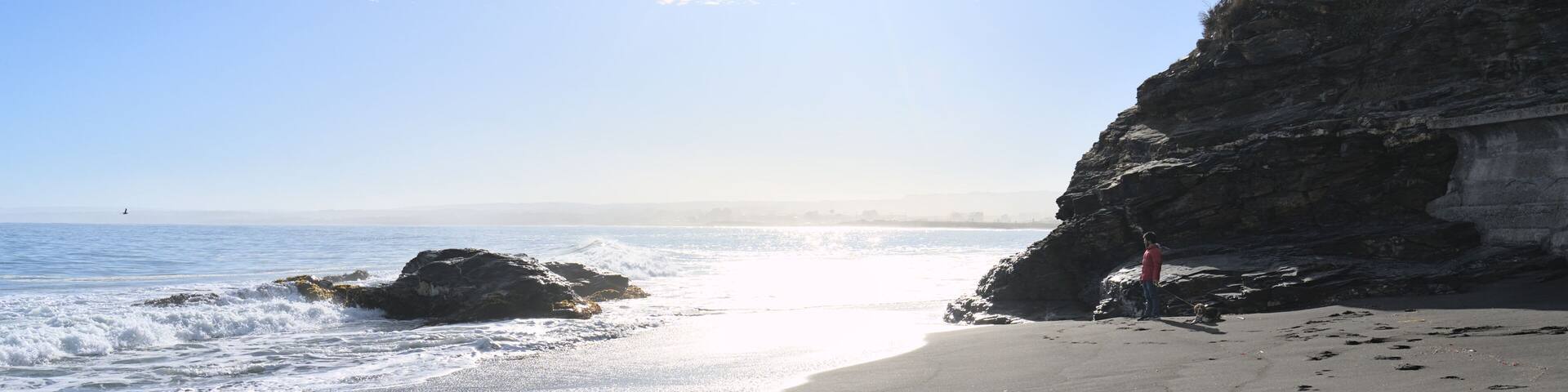 sea and rocks on the beach during low tide (Pelluhue, Chile)