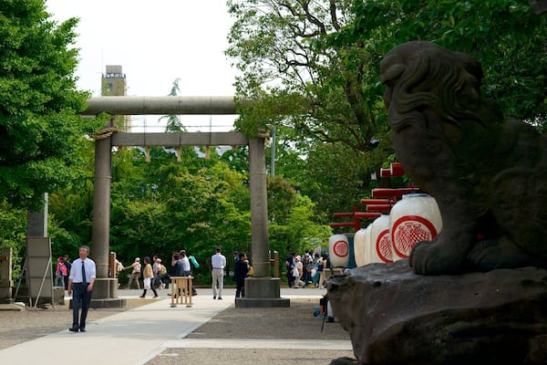 Asakusa Shrine showing outdoor art, a temple or place of worship and a garden