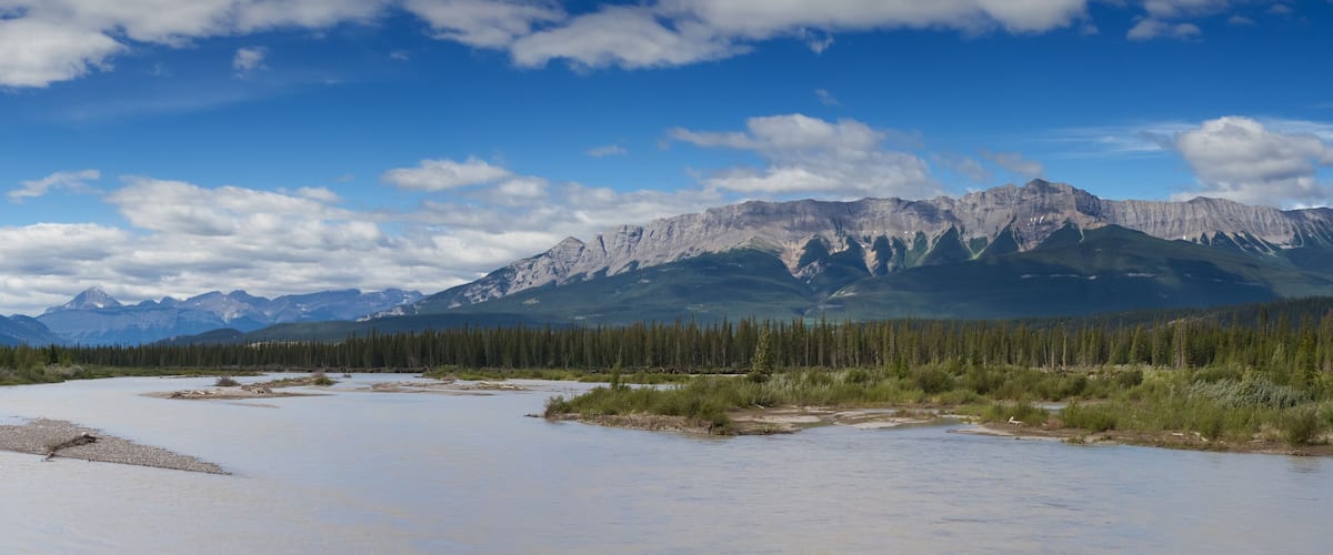 A river with mountains in the background.