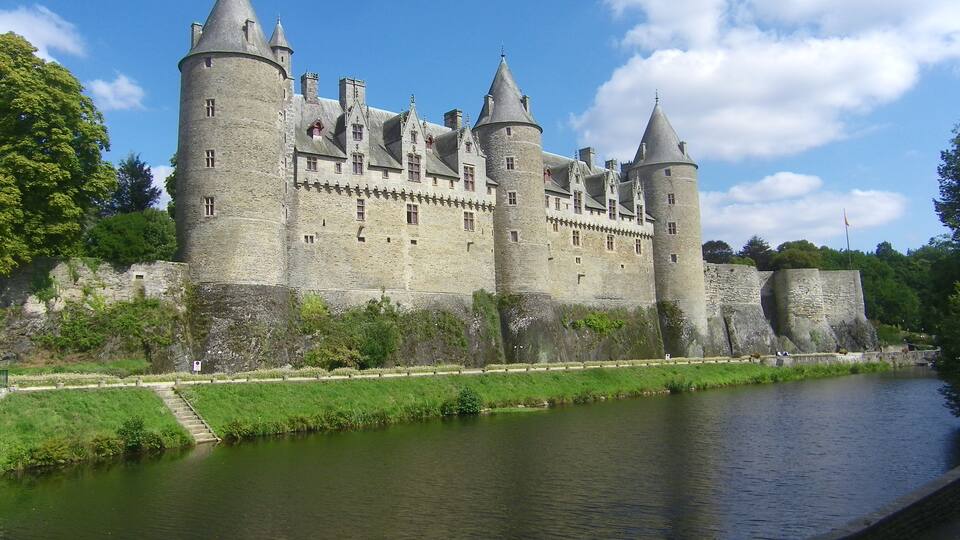 A historic castle with multiple towers and a moat.