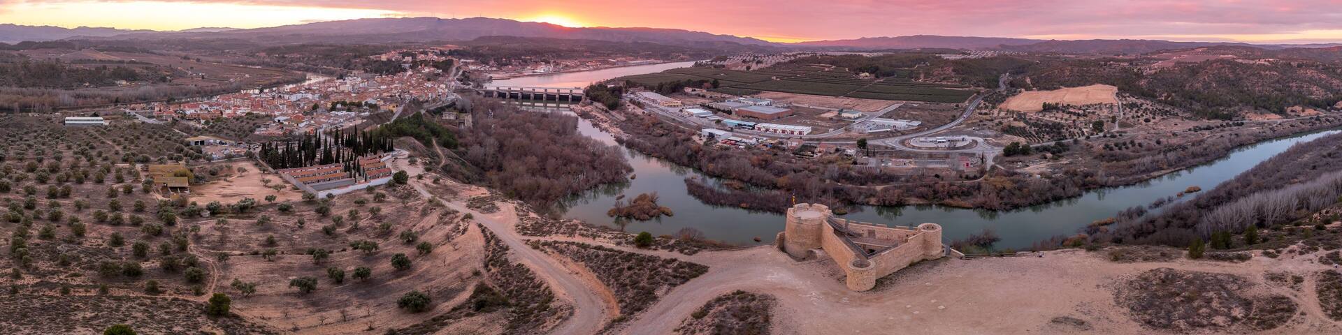 Aerial colorful sky sunset panoramic view of Flix new castle above the Ebro river in Spain with triangular shape circular gun platforms