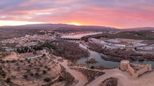 Aerial colorful sky sunset panoramic view of Flix new castle above the Ebro river in Spain with triangular shape circular gun platforms