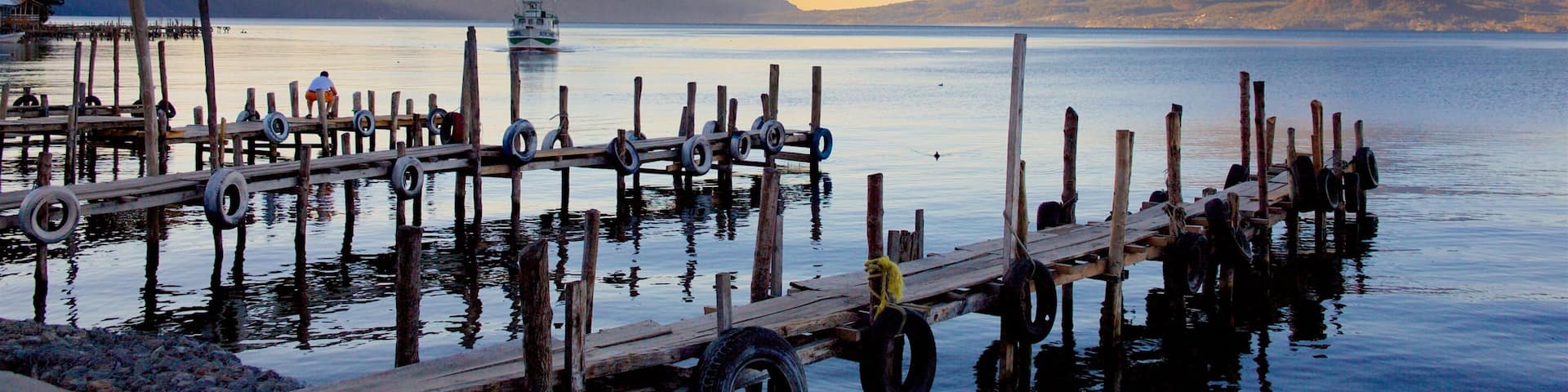 Guatemala featuring a sunset, mountains and a lake or waterhole