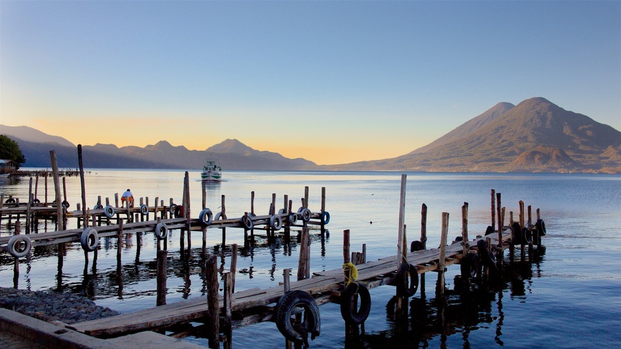 Guatemala which includes a sunset, mountains and a lake or waterhole