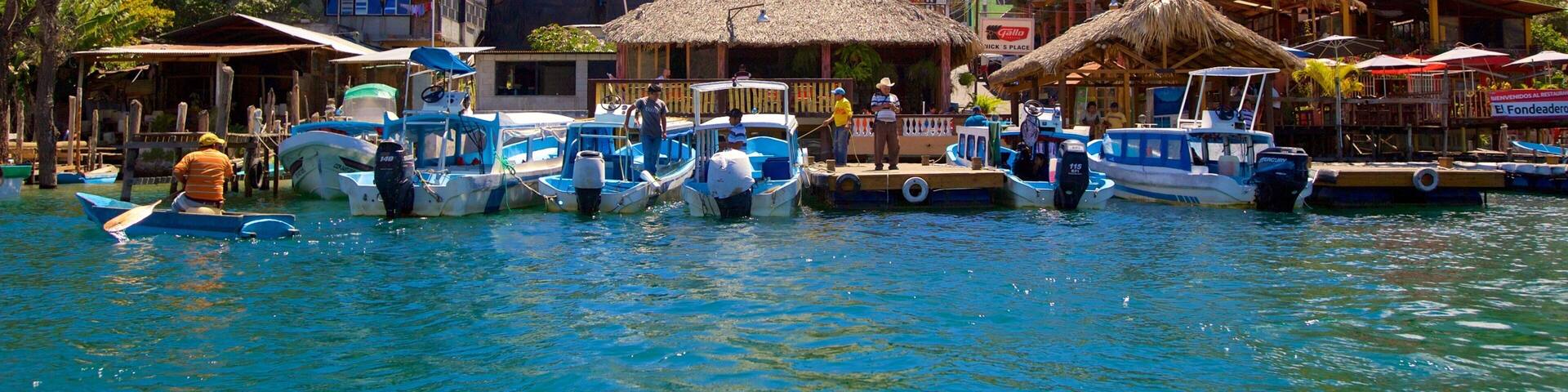 Santiago Atitlan showing a coastal town and a bay or harbor