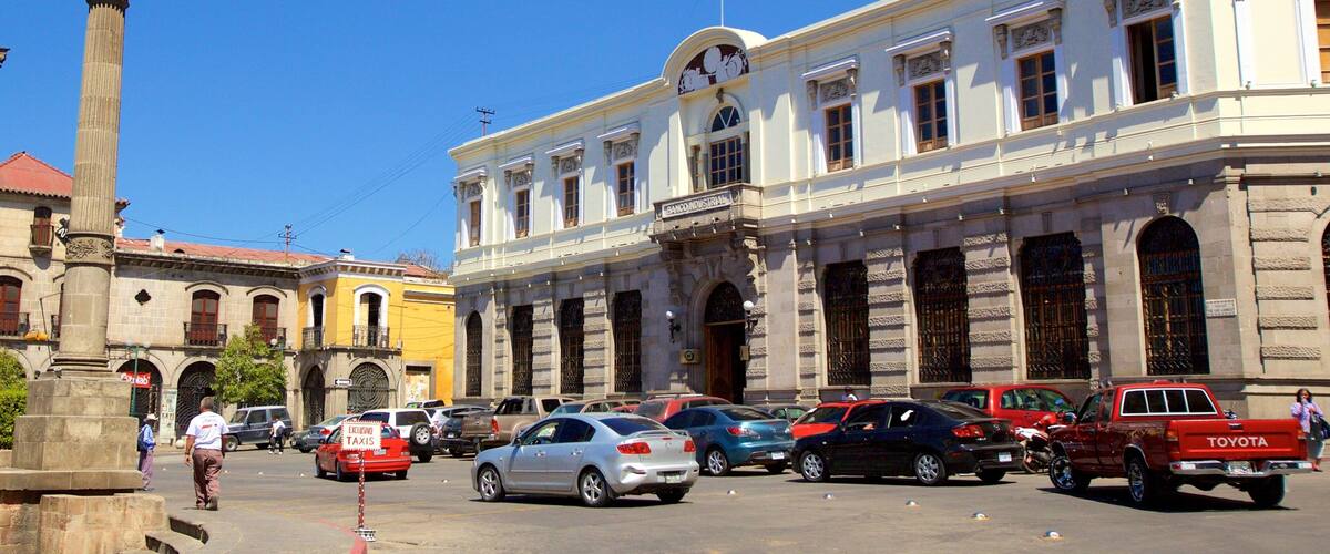 A historic building with columns and a clock tower.