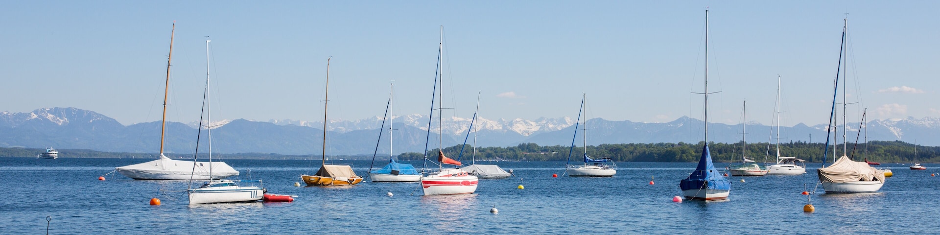 Panorama with anchoring sailboats at Starnberger See.