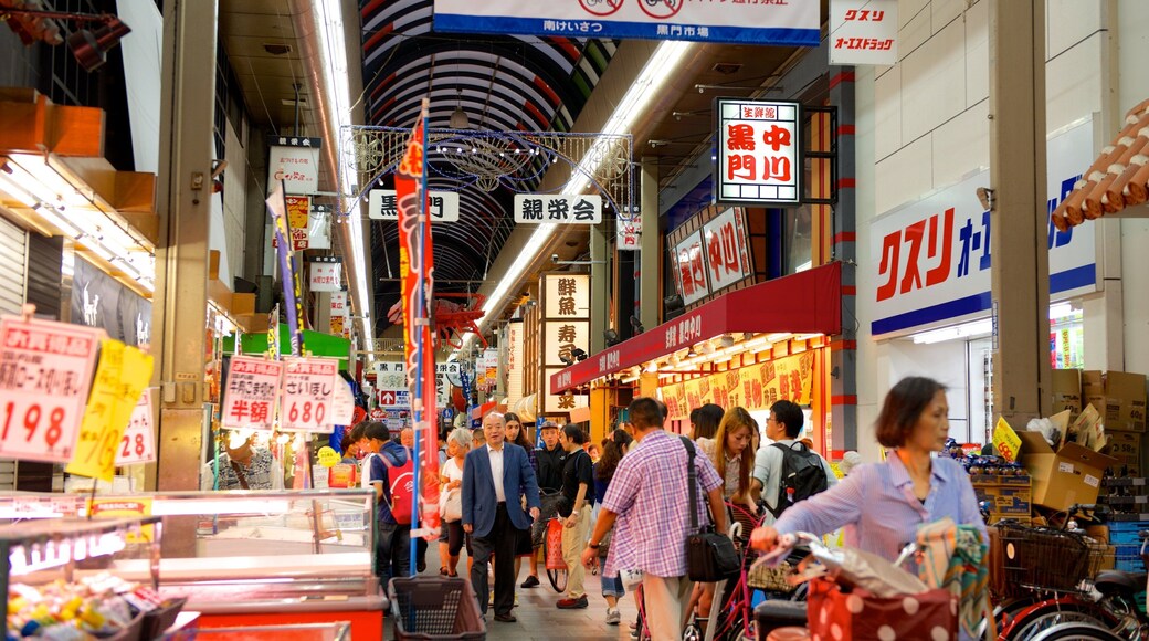 Kuromon Ichiba Market which includes a city and interior views as well as a large group of people