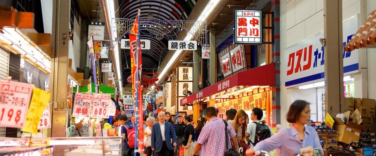 Kuromon Ichiba Market which includes a city and interior views as well as a large group of people
