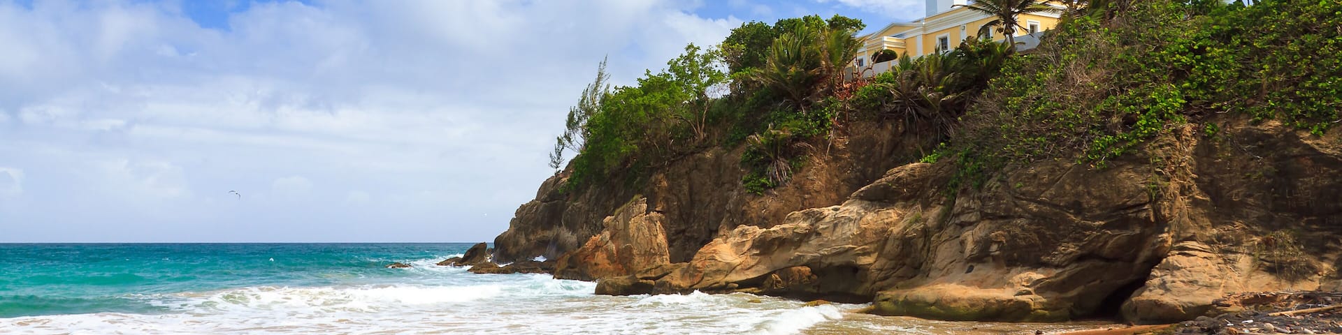 Puerto Rico coastline beach at Punta Tuna lighthouse in summer with a blue sky and clouds