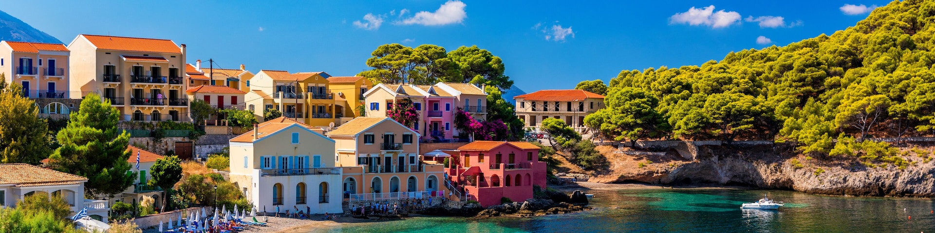 Assos village in Kefalonia, Greece. Turquoise colored bay in Mediterranean sea with beautiful colorful houses in Assos village in Kefalonia, Greece, Ionian island, Cephalonia, Assos village.