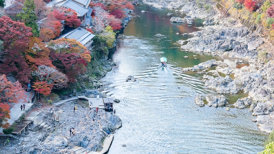 colorful leaves mountains and Katsura river in Arashiyama, landscape landmark and popular for tourists attractions in Kyoto, Japan. Fall Autumn season, Vacation,holiday and Sightseeing concept
