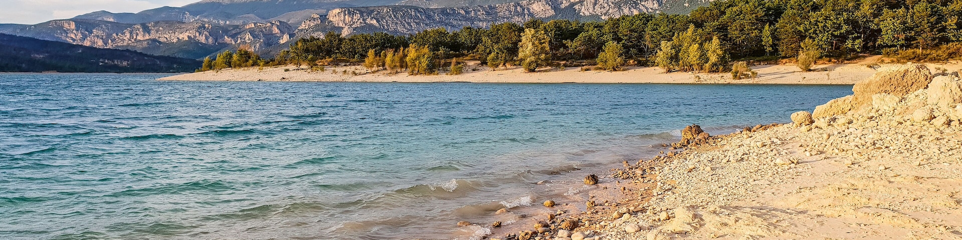Pebbles beach on the shore of the lake of Sainte-Croix in Les Salles-sur-Verdon, department of Var in the south of France