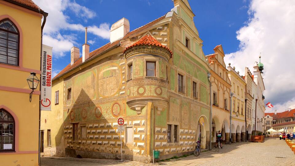 A historic building with ornate frescoes and a red-tiled roof.