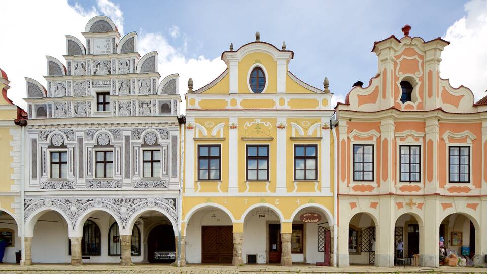 A row of colorful buildings with intricate architectural details and arched doorways.