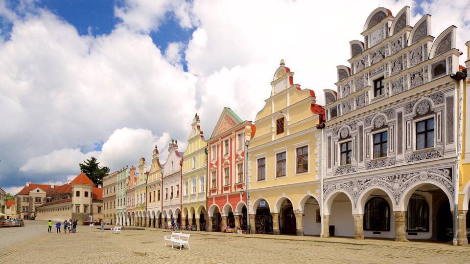A historic European square with colorful buildings, cobblestone pavement, and ornate architecture.