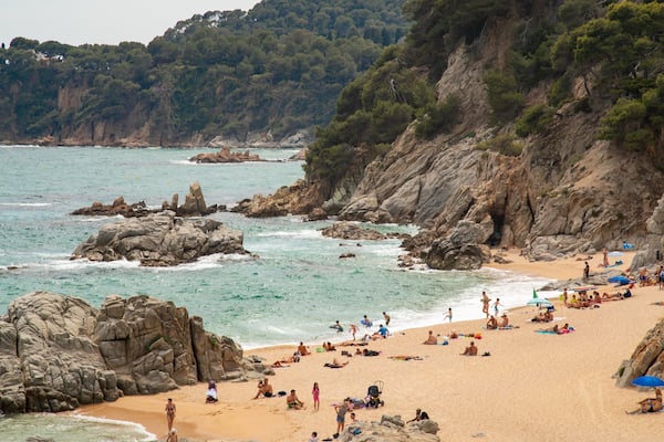 Cala Boadella Beach featuring a sandy beach, general coastal views and rugged coastline