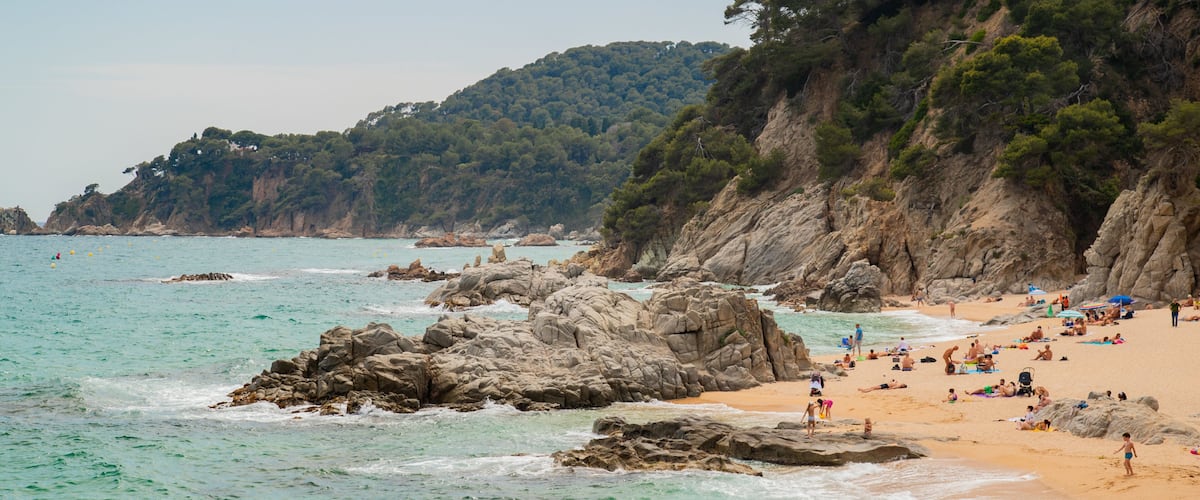 Cala Boadella Beach featuring general coastal views, rocky coastline and a sandy beach