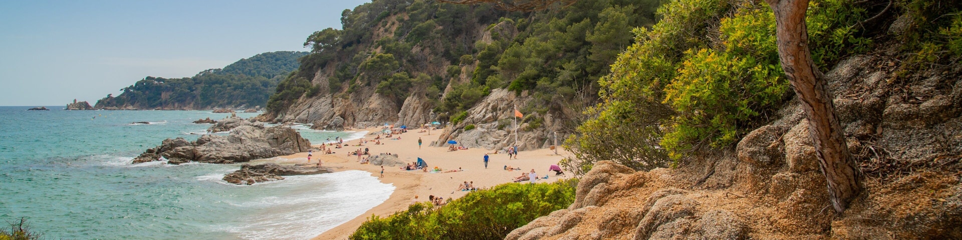 Cala Boadella Beach which includes a sandy beach, rugged coastline and general coastal views