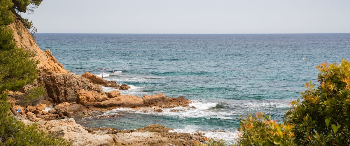 Cala Boadella Beach featuring rocky coastline and general coastal views