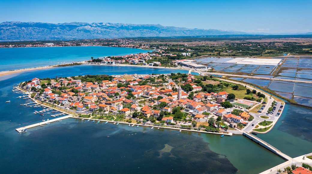 Historic town of Nin laguna aerial view with Velebit mountain background, Dalmatia region of Croatia. Aerial view of the famous Nin lagoon and medieval in Croatia