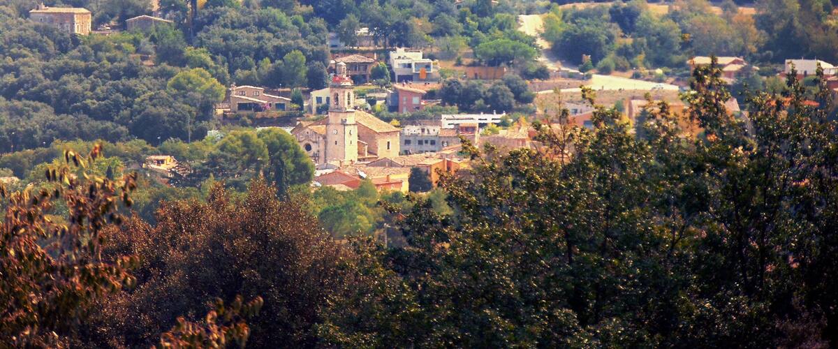 A rural landscape with a village, scattered houses, and a prominent church.