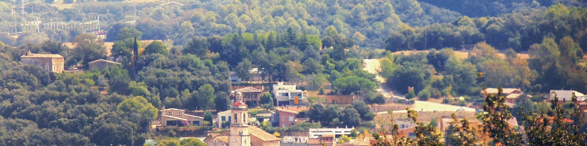 A rural landscape with a village, scattered houses, and a prominent church.