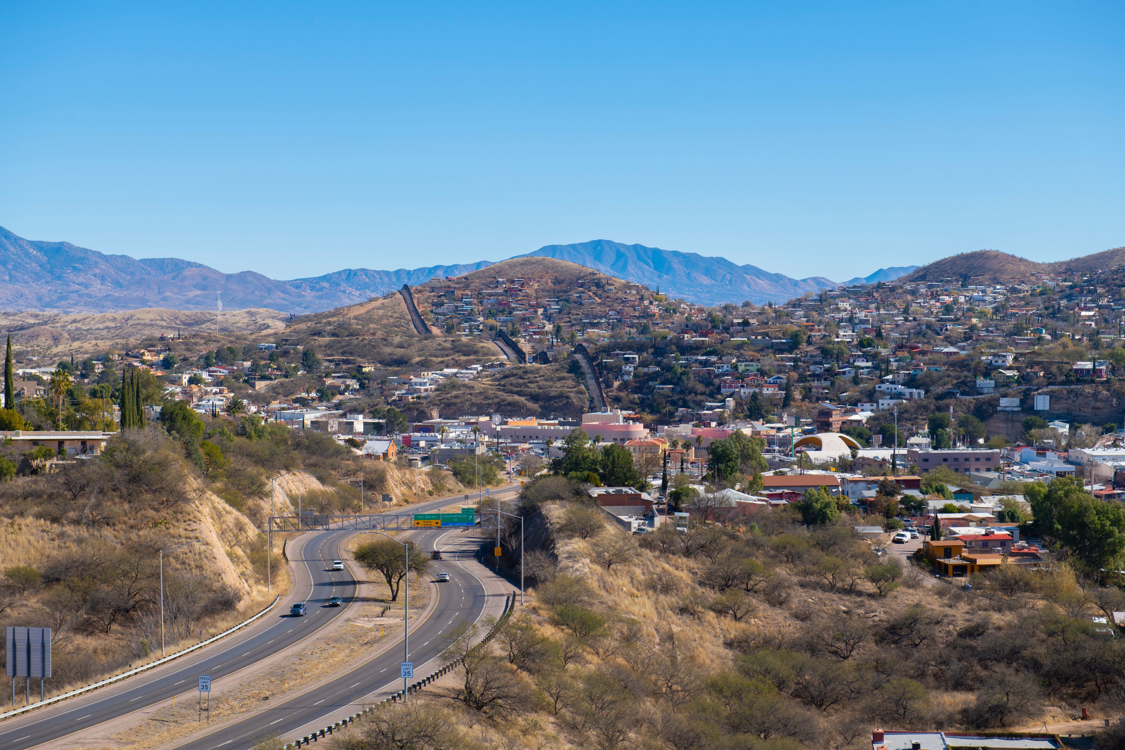 Aerial view of Nogales Sonora with Border Wall between Nogales Arizona USA and Nogales Sonora Mexico near International Street in city of Nogales, Arizona AZ, USA. 