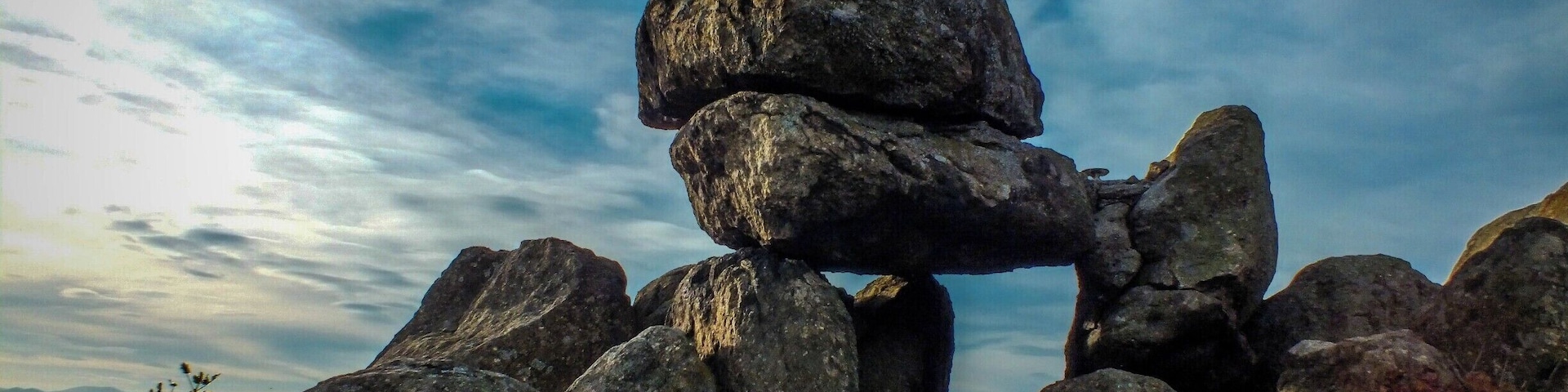 "The door of the goddess" (also known as "The sun door") is one of the most ancient Thracian sanctuaries found in the Bulgarian lands. It is located south of the village of Buzovgrad and can be reached by a well marked eco-path starting from the village.
The Megalith dating from 1800-1600 BC. and was built by the ancient Thracians. It is situated at hill and represents group of stone blocks (trilit). The largest of them are placed horizontally over others and form a hole like a window. There are other interesting rock structures around as so called "The Throne" (for the observer of the rituals) and "zhervenik".
It is assumed that the complex was used not only for cults and rituals,but also for astronomical observations and as a calendar. In recent years, on 21 June (the day of the summer solstice), the sanctuary attracts many people who watch the entry of the solar disk into the the rock hole of the sanctuar.
