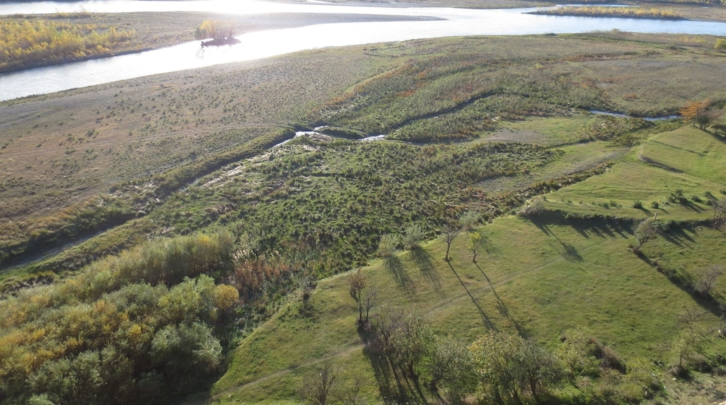 Looking off the cliff at the Uplistsikhe rock and cave complex outside of Gori, Georgia.
Uplistsikhe is an extremely old city that was carved out of rock located on the side of a hill. After climbing to the top of this complex, it becomes easily apparent as to why ancient people chose this spot to construct a city - it provides a sweeping view of the river valley below.
This picture is looking down at sunlight shining off the river.