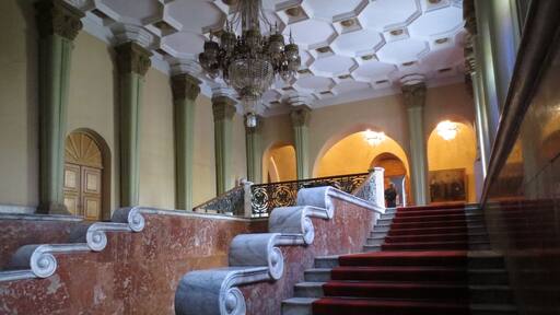 View of a staircase inside of the Stalin Museum in Gori, Georgia.
Gori is a relatively small town located about 80 kilometers from Tbilisi.
Joseph Stalin (his last name is a play on the Russian word for "steel" - his real last name was the Georgian surname of Jugashvili) was born and raised in Gori, and this museum houses both the small boarding house he was born in, and his train car.
It's certainly worth a visit if you're in Georgia. Price is 10 GEL for a ticket - and they have english speaking tour guides available.
I'll let you make up your own mind about the politics of the place, but I will say that the tour had some laugh out loud understatements like: "Stalin and the Soviet mades some mistakes, such as the forced collectivization of agriculture in Ukraine."
I would bet Germans would probably be the most interested - if you've ever been to Germany you'd understand what I mean.