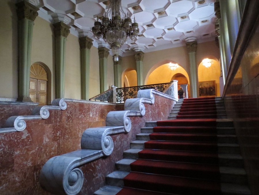 View of a staircase inside of the Stalin Museum in Gori, Georgia.
Gori is a relatively small town located about 80 kilometers from Tbilisi.
Joseph Stalin (his last name is a play on the Russian word for "steel" - his real last name was the Georgian surname of Jugashvili) was born and raised in Gori, and this museum houses both the small boarding house he was born in, and his train car.
It's certainly worth a visit if you're in Georgia. Price is 10 GEL for a ticket - and they have english speaking tour guides available.
I'll let you make up your own mind about the politics of the place, but I will say that the tour had some laugh out loud understatements like: "Stalin and the Soviet mades some mistakes, such as the forced collectivization of agriculture in Ukraine."
I would bet Germans would probably be the most interested - if you've ever been to Germany you'd understand what I mean.