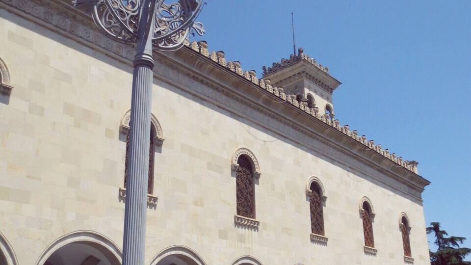 A historic building with arched windows and a central tower.